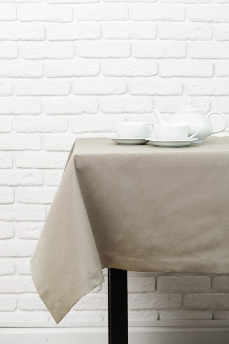 Table Covers Cloth 1 Beige Tablecloth White Brick Wall Teacups Teapot by Orient Uniforms for customers in Dubai, Abu Dhabi, Sharjah, Ajman and across the UAE
